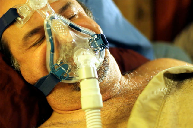 Man wearing CPAP device